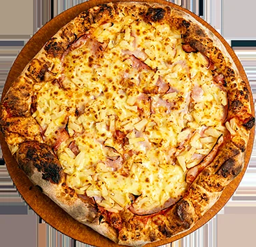 Hawaiian pizza with ham and pineapple on a wooden table